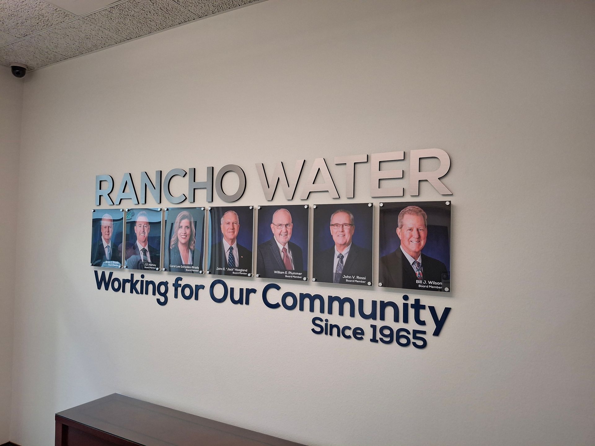 Rancho Water wall sign reading “Working for Our Community Since 1965” with photos of leaders