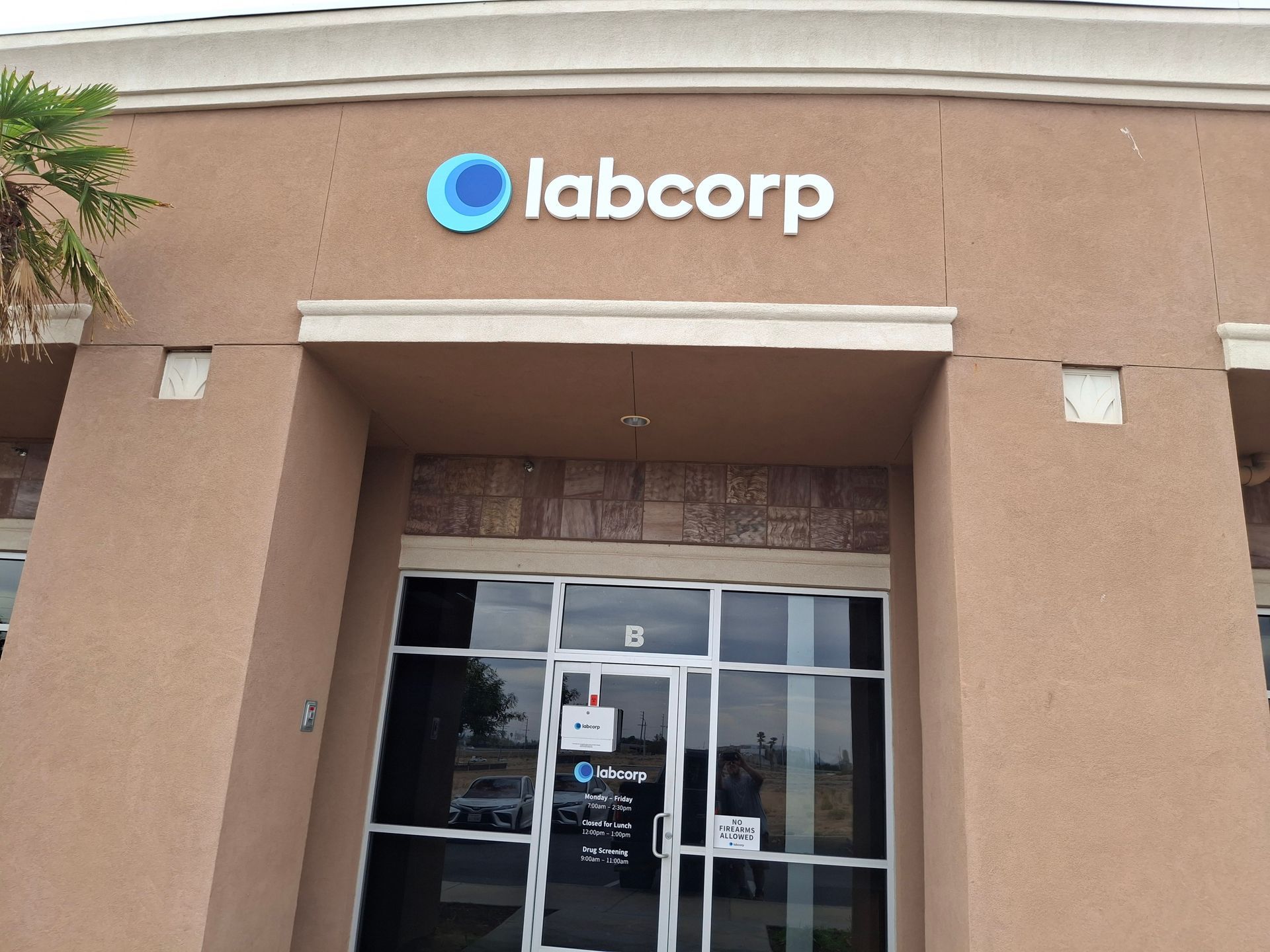 Labcorp storefront entrance with blue logo on a tan building