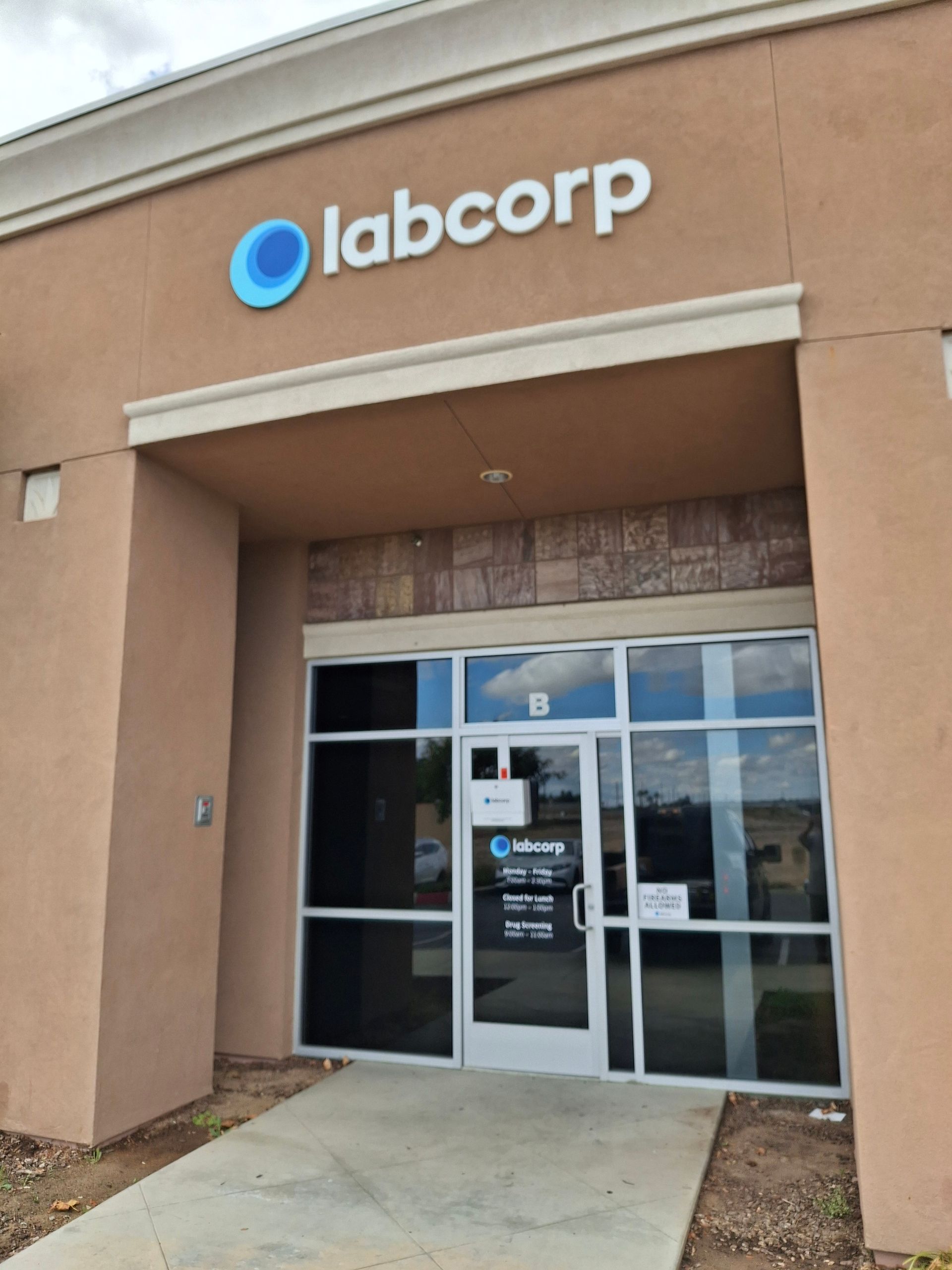 Labcorp storefront entrance with glass doors and tan exterior walls