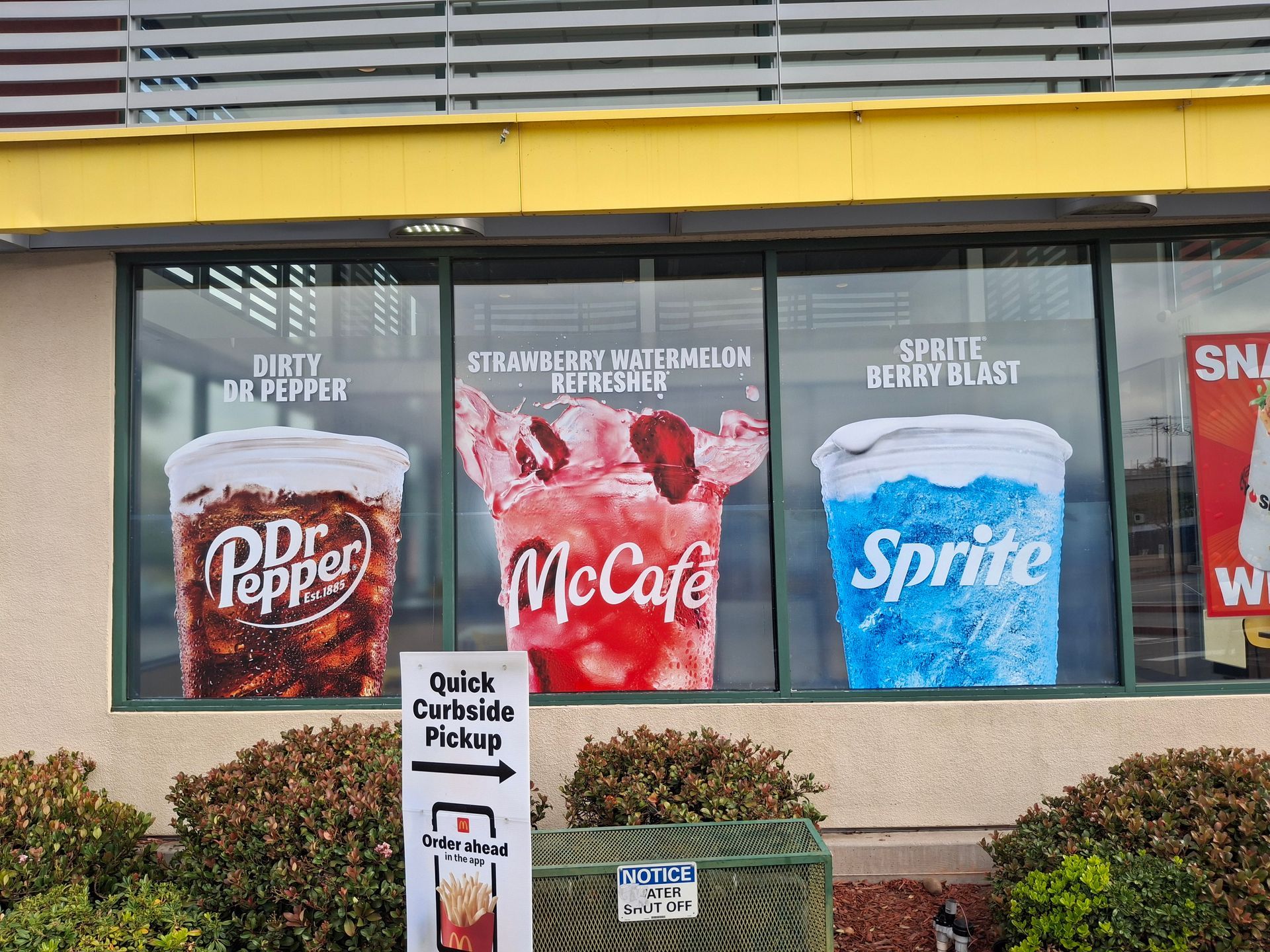 Restaurant window ads for Dr Pepper, McCafé, and Sprite drinks shown in large cups