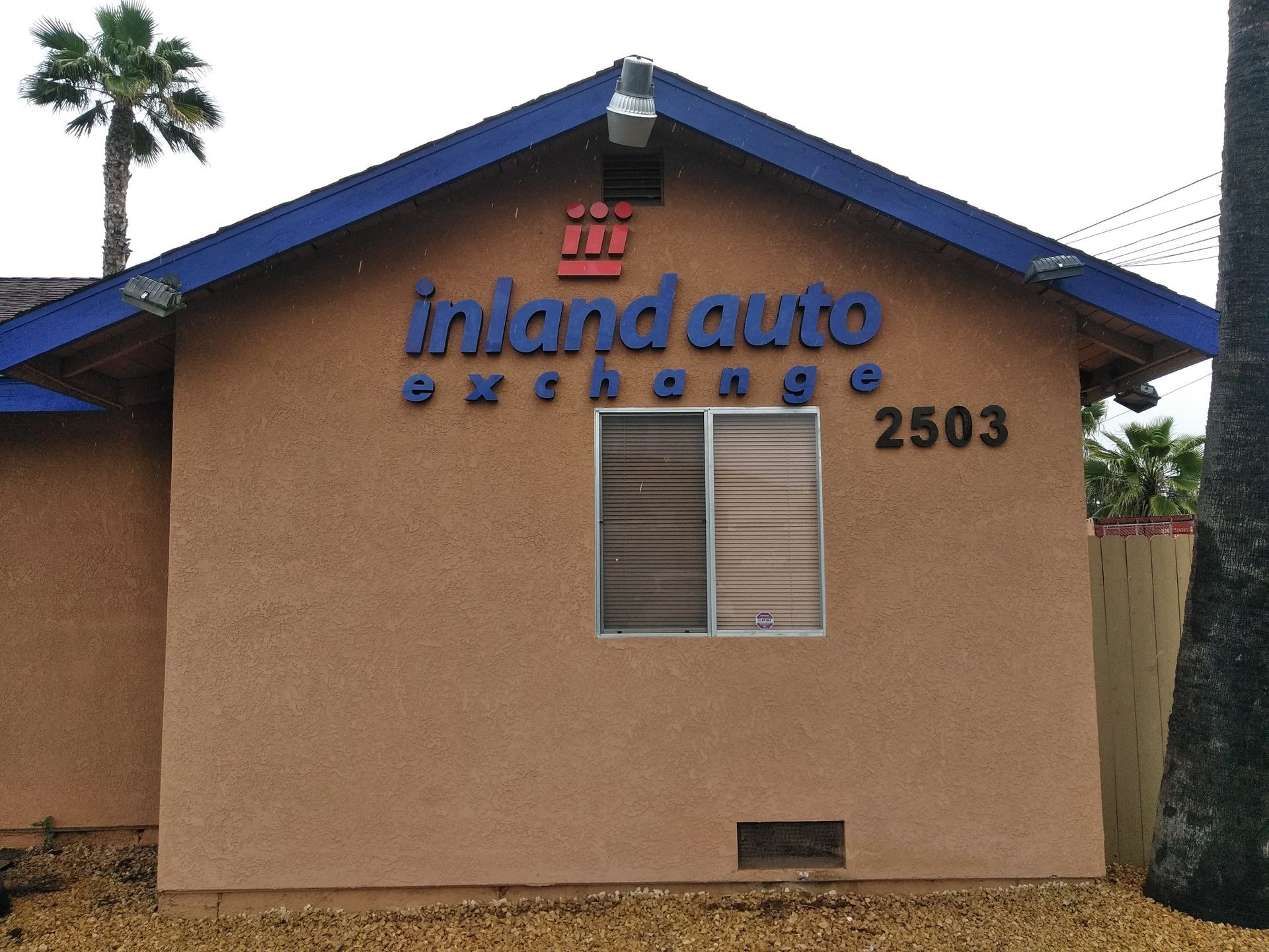 Tan stucco building with blue trim, 