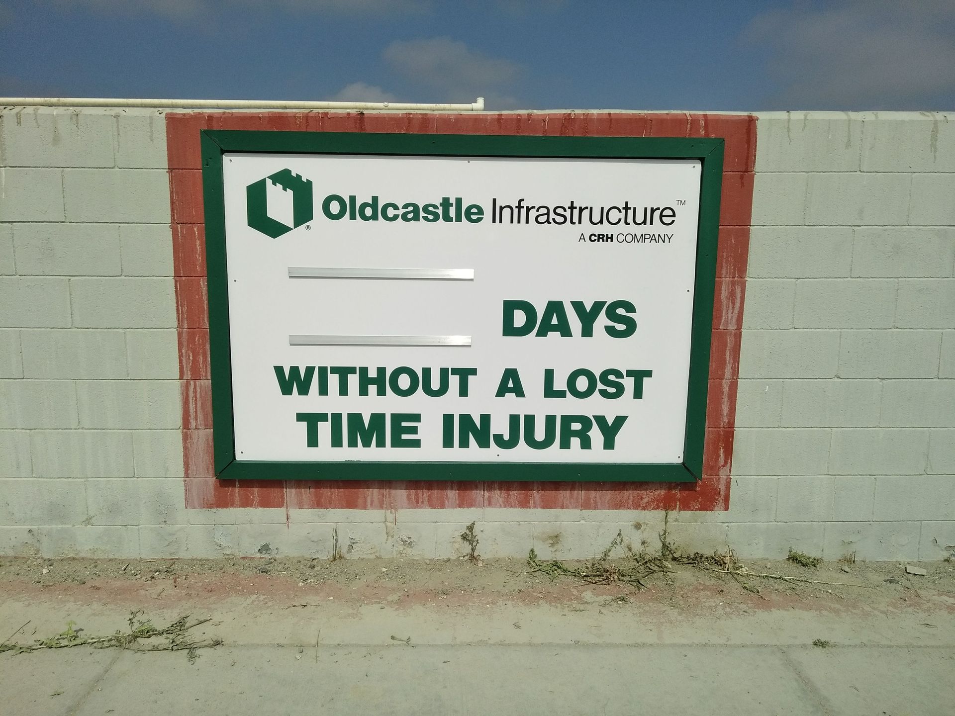 Oldcastle Infrastructure safety sign on a wall reading “Days without a lost time injury”