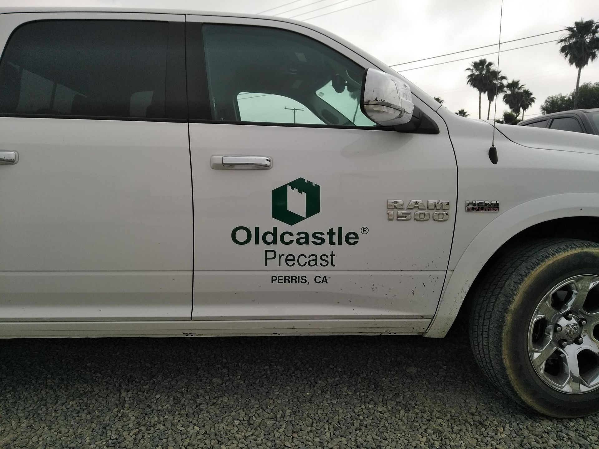 White Oldcastle Precast pickup truck parked outdoors on a cloudy day