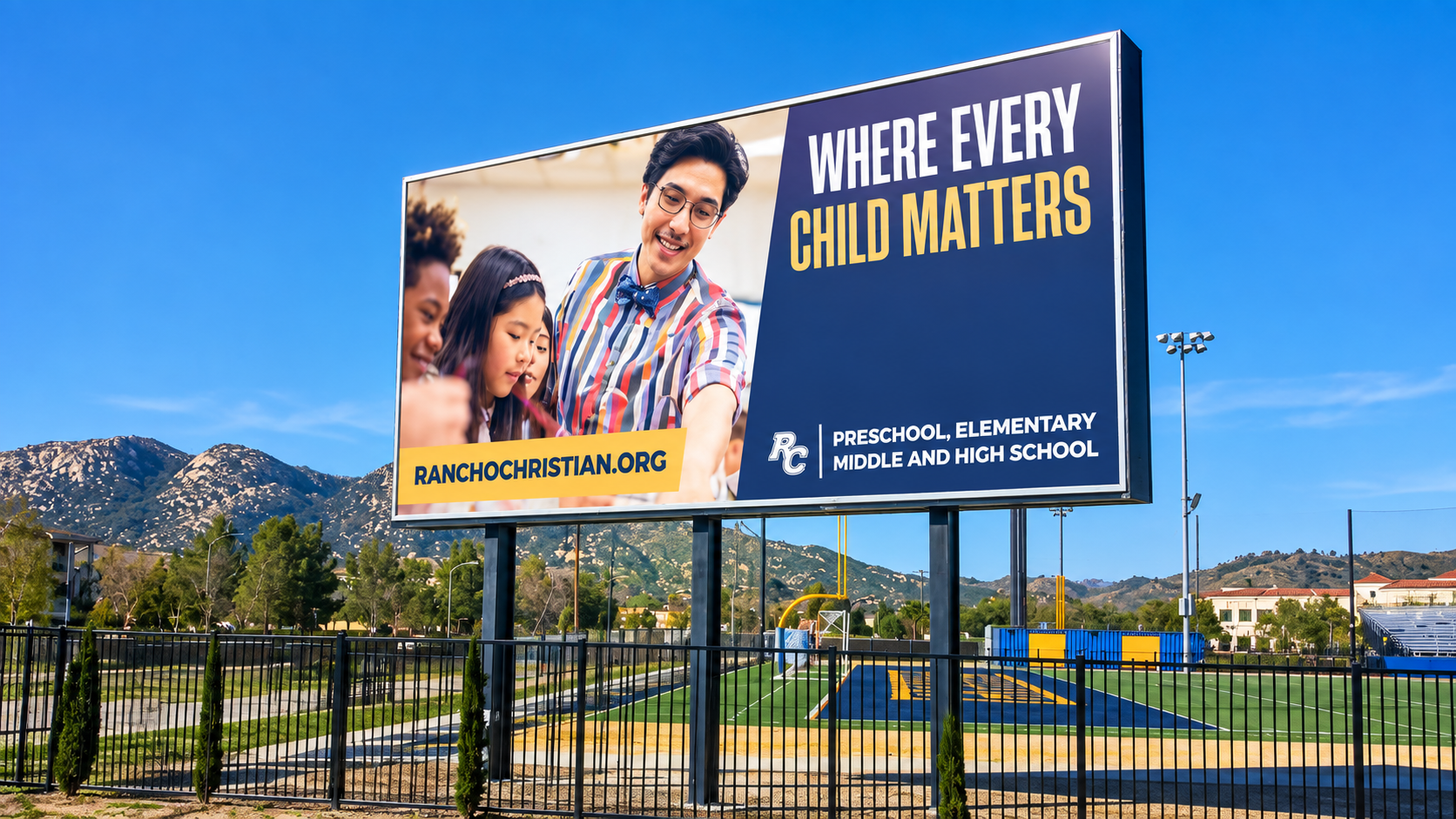 Billboard for Masood & Hasan DDS with smiling man, reading “WHERE EVERY CHILD MATTERS,” by a school fence and mountains.