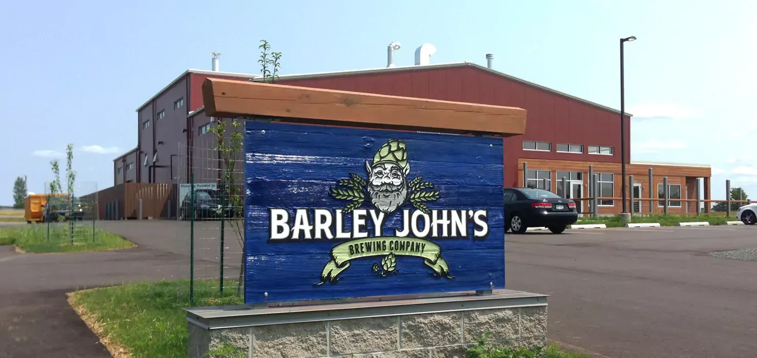 A blue sign that says barley john 's is in front of a building.