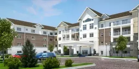 An artist 's impression of a large apartment building with cars parked in front of it.