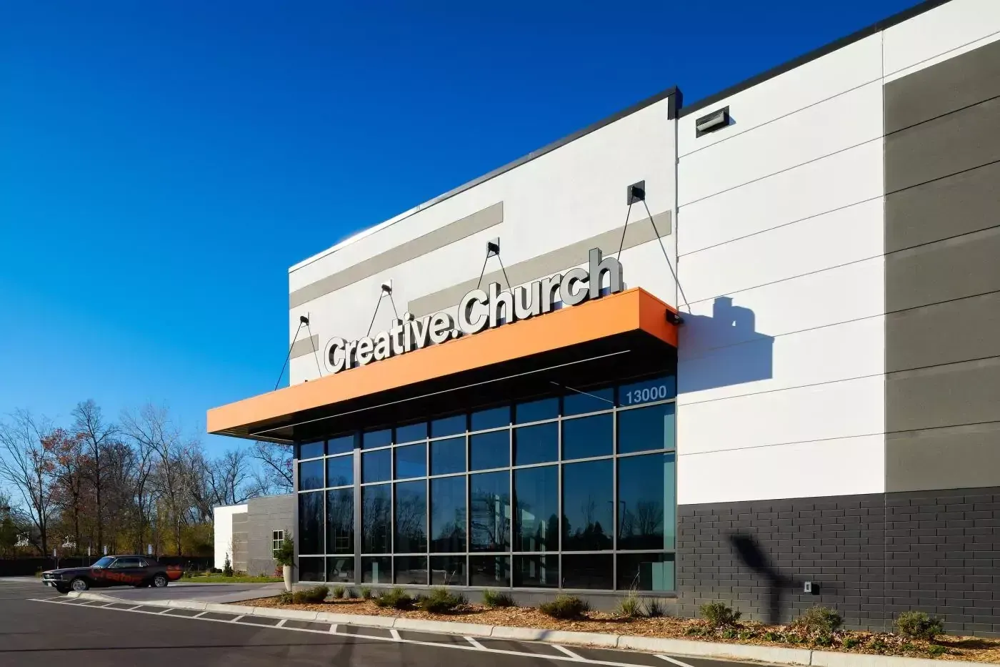 A large building with a lot of windows and the word creative church on it.