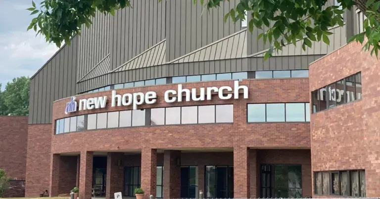 A large brick building with a sign that says new hope church