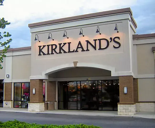A kirkland 's store has a large sign above the entrance