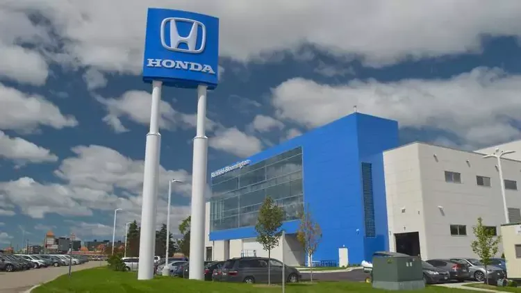 A blue and white building with a honda sign in front of it
