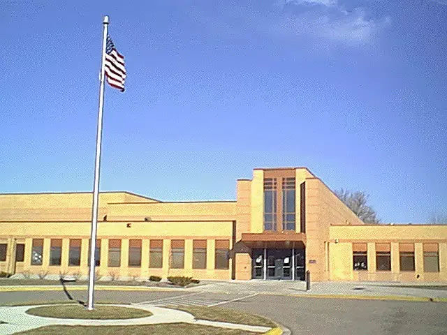 An american flag is flying in front of a building
