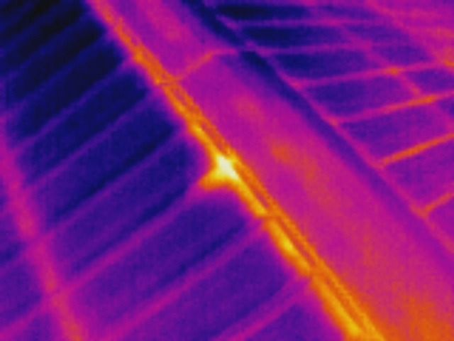 Thermal image of a solar panel with a hot spot, indicating a potential defect.
