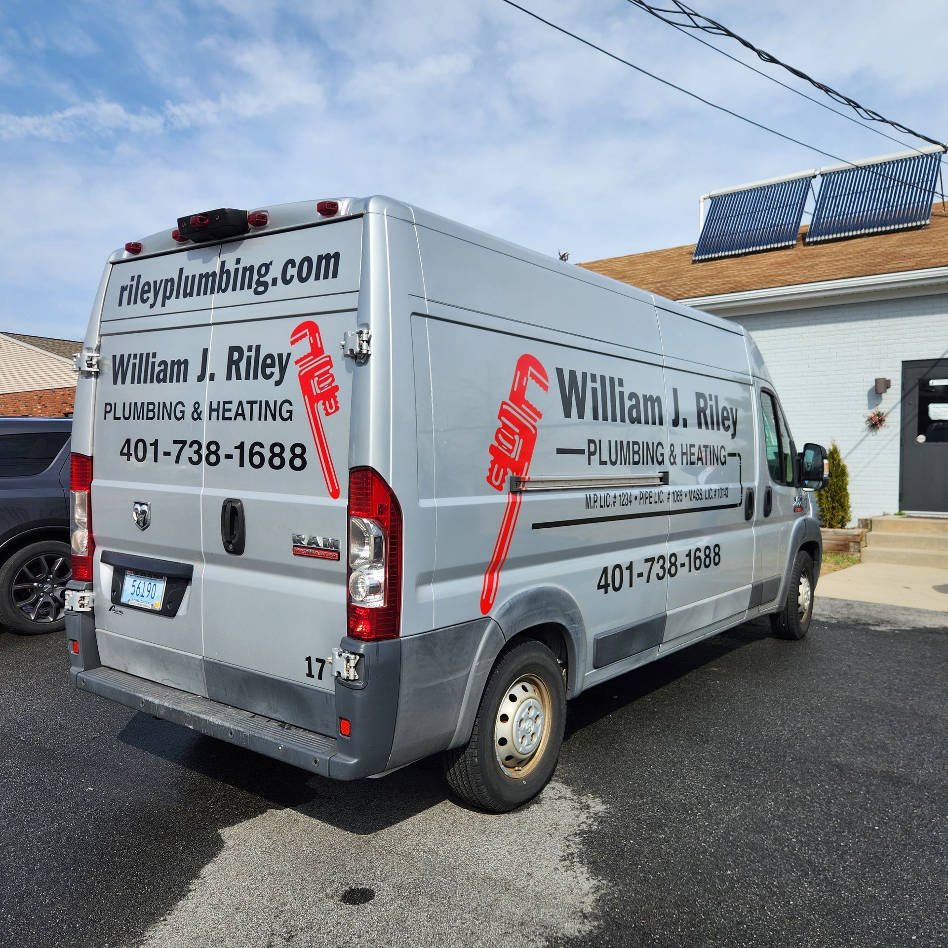 A william j. riley van is parked in front of a building
