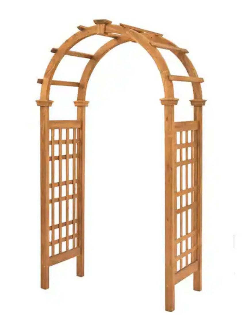 Wooden garden arbor trellis with lattice sides and arched top, in light brown