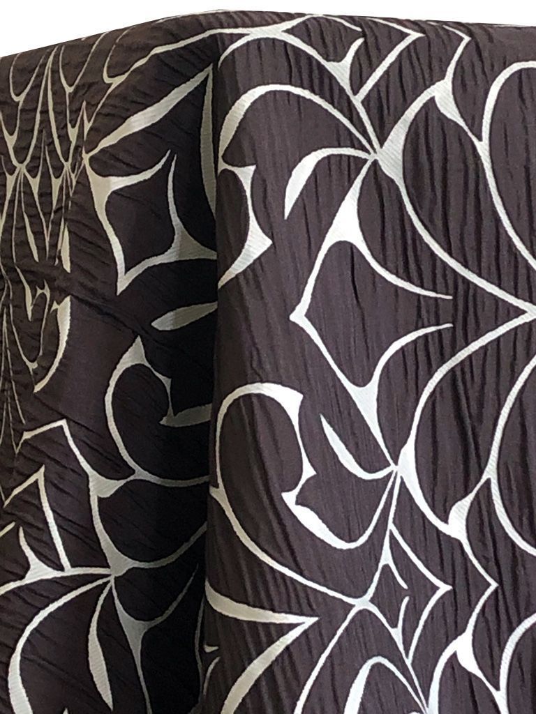 Brown fabric with silver floral pattern.