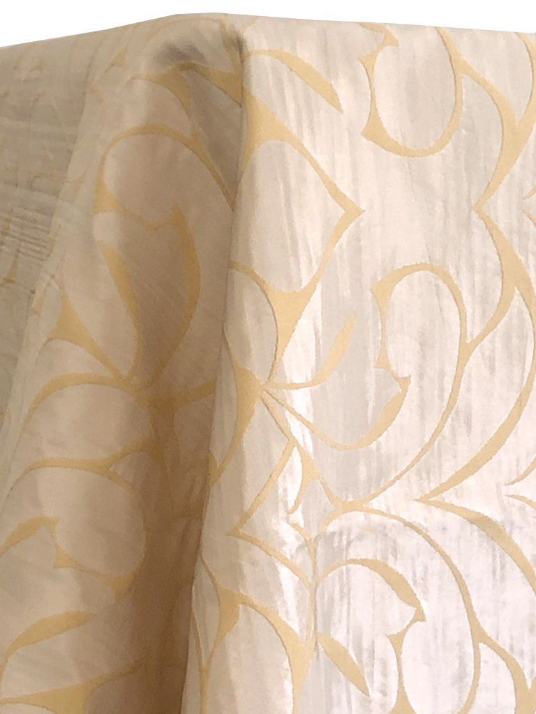 Cream-colored fabric with light gold swirling pattern.