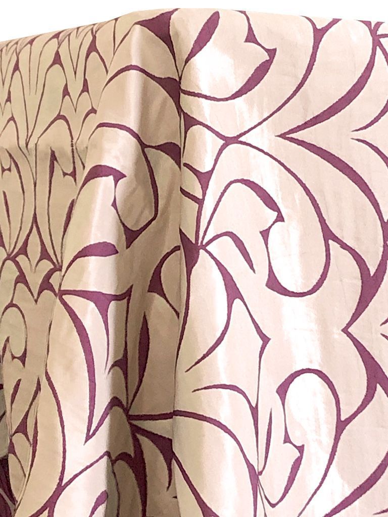 Cream tablecloth with large, dark purple floral design.