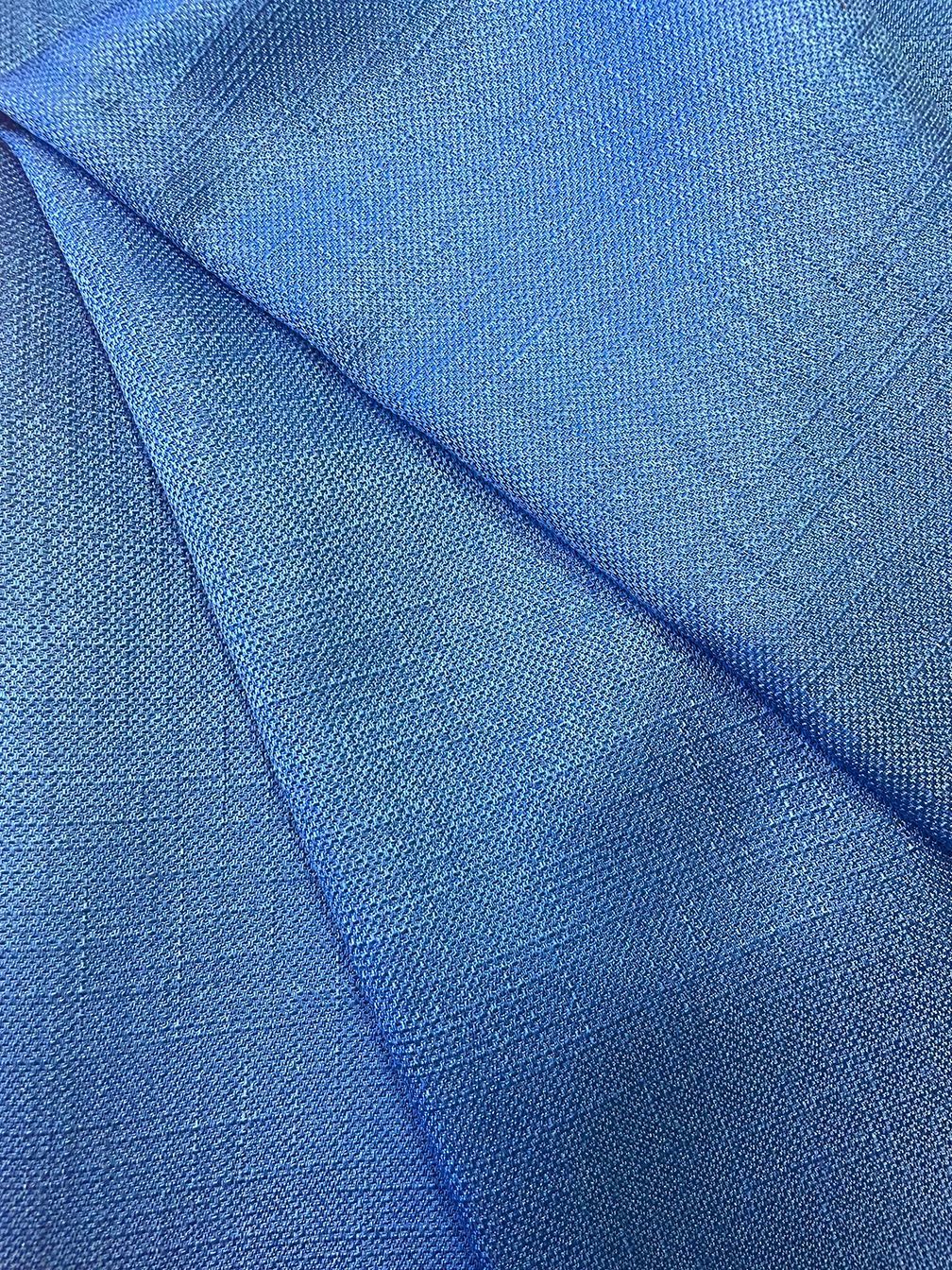 Blue shimmering fabric draped in folds.