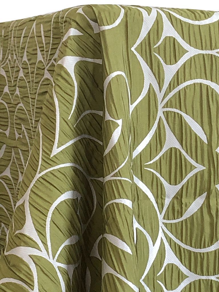 Green and white patterned fabric draped over a surface.