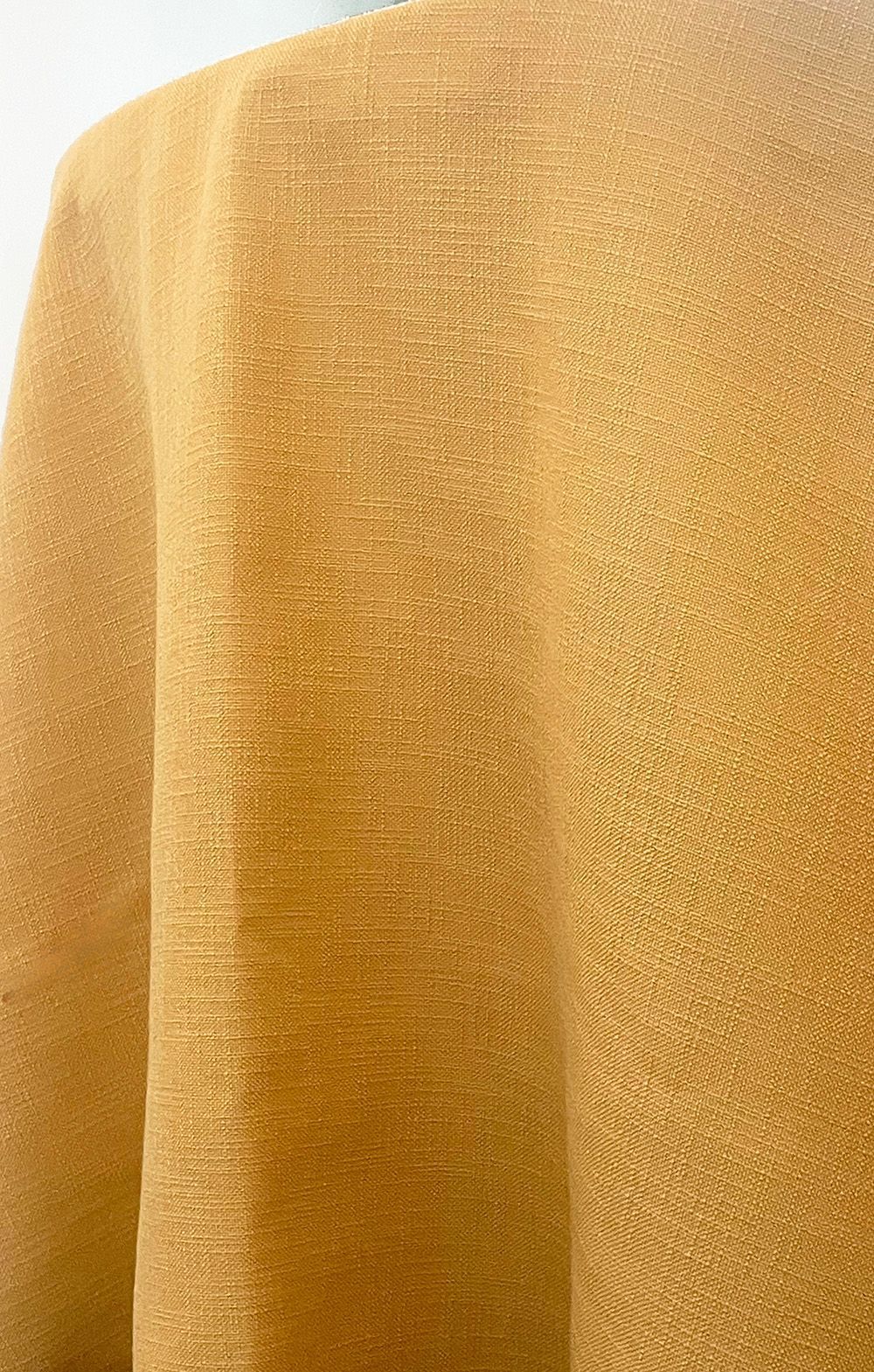 Gold fabric draped in folds.