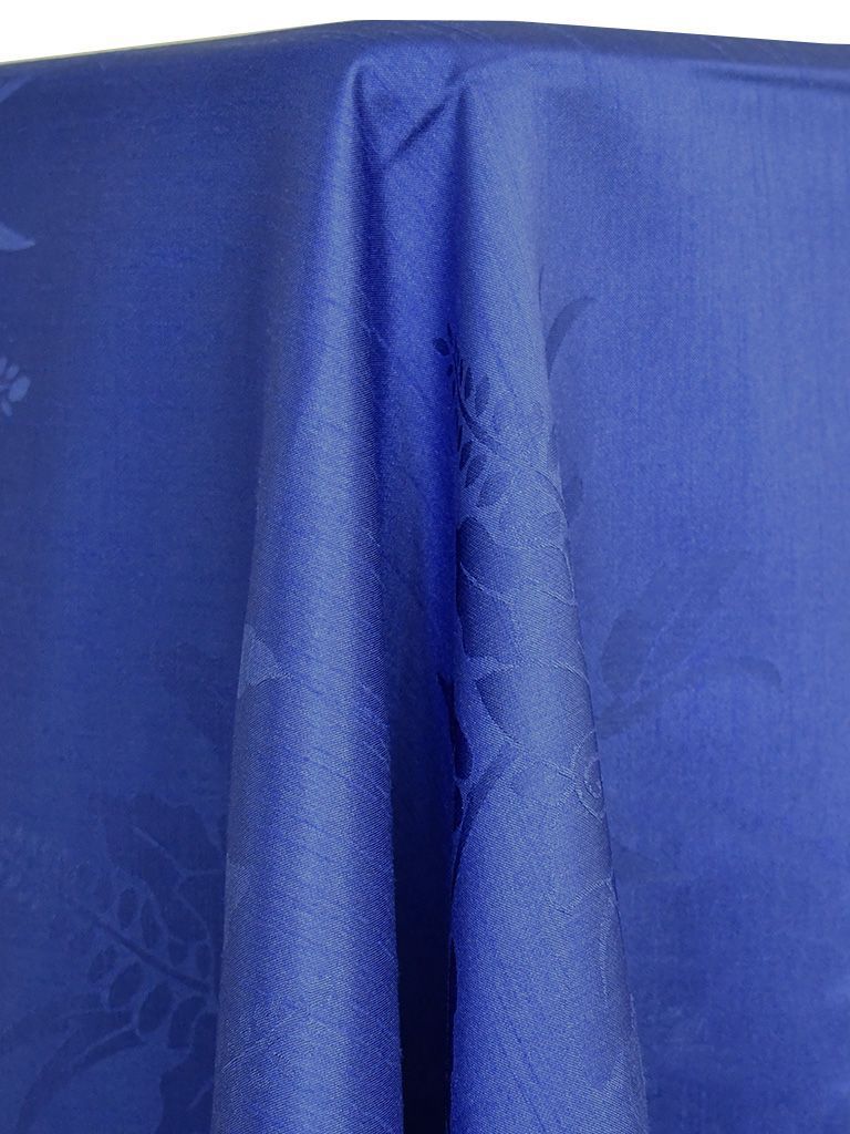 Blue tablecloth with subtle floral pattern draped over a surface.