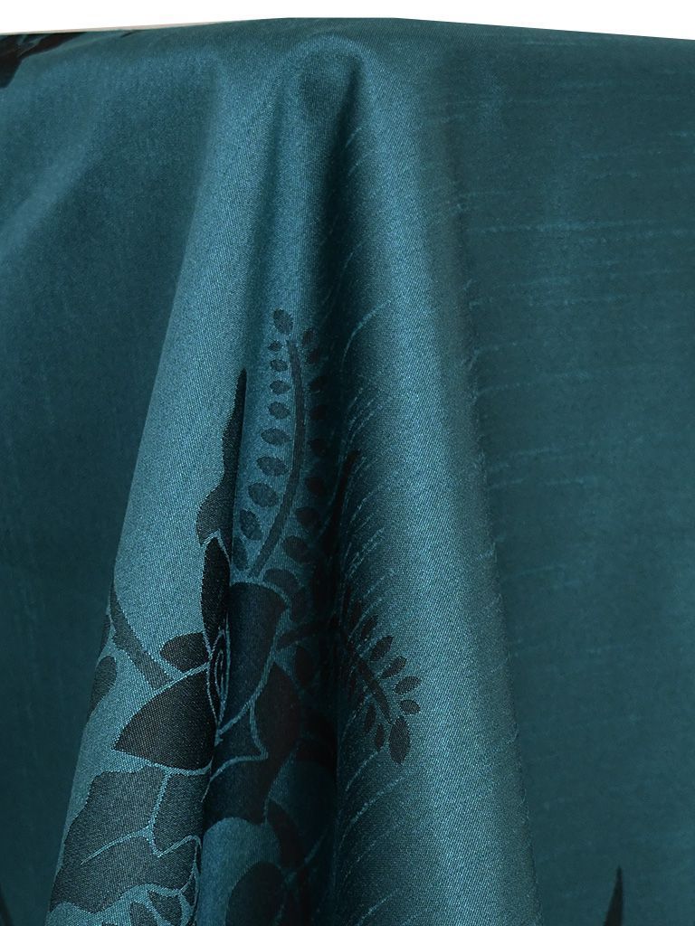 Teal fabric with a dark floral pattern.