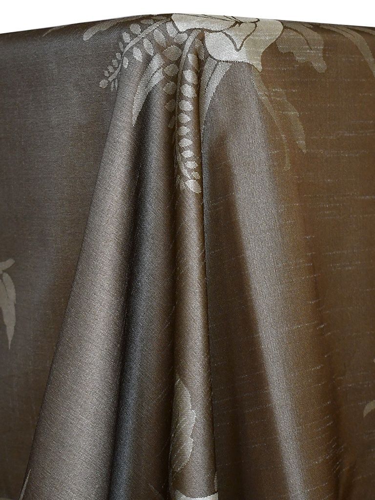 Dark brown fabric tablecloth with subtle floral pattern.