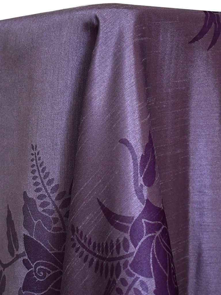 Purple fabric with floral and leaf designs.