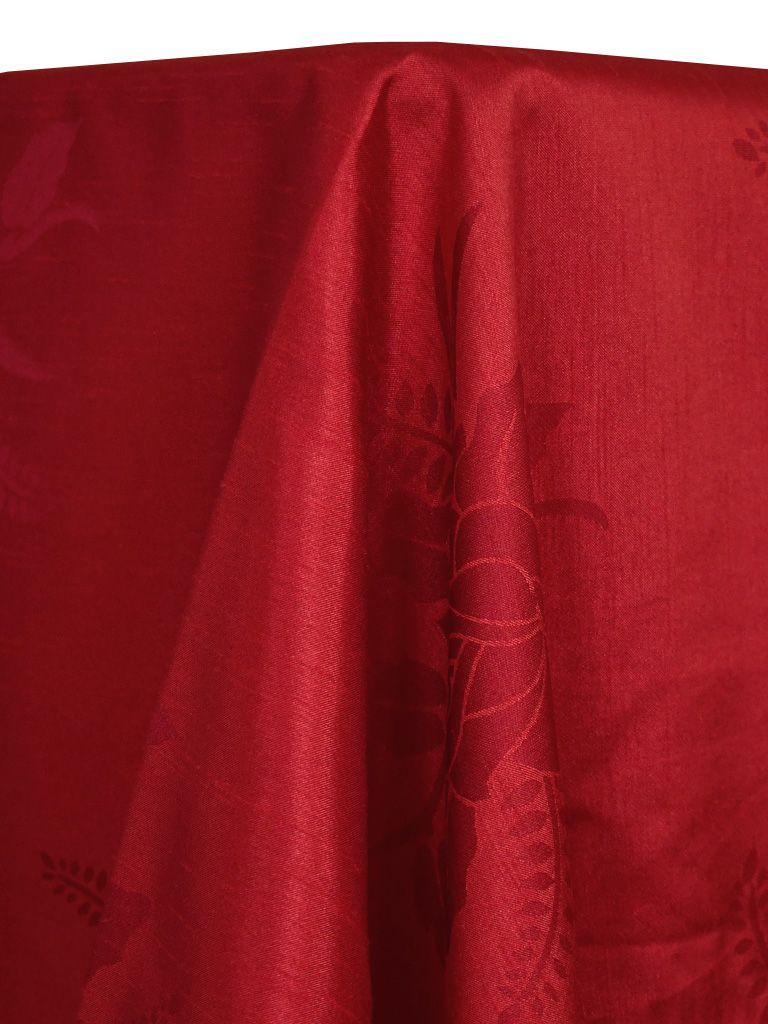 Close-up of a draped, red fabric tablecloth with subtle floral pattern.
