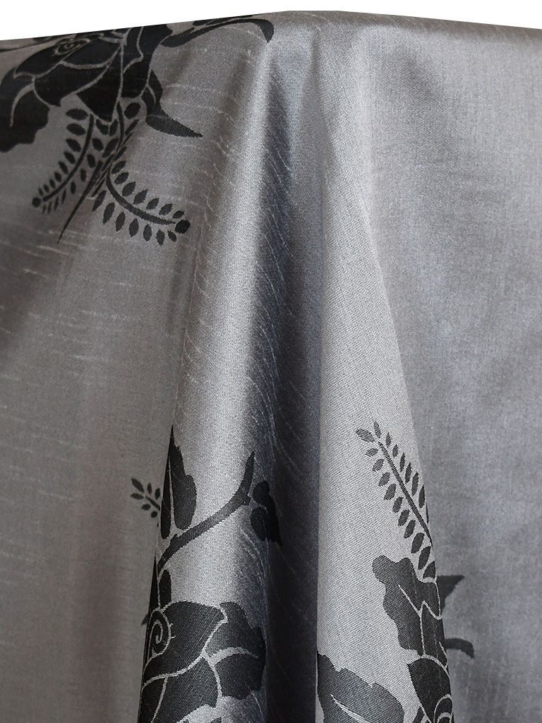 Gray fabric with black floral pattern, draped.