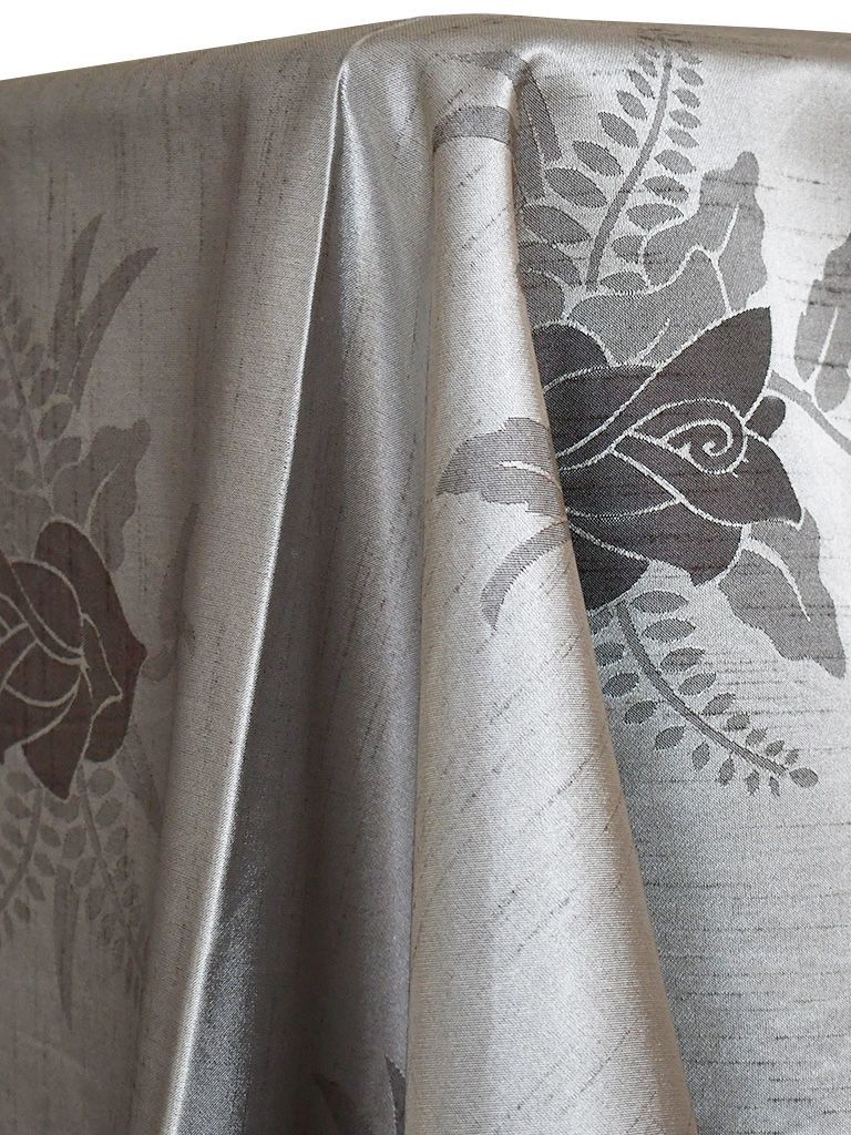 Silver tablecloth with floral design.