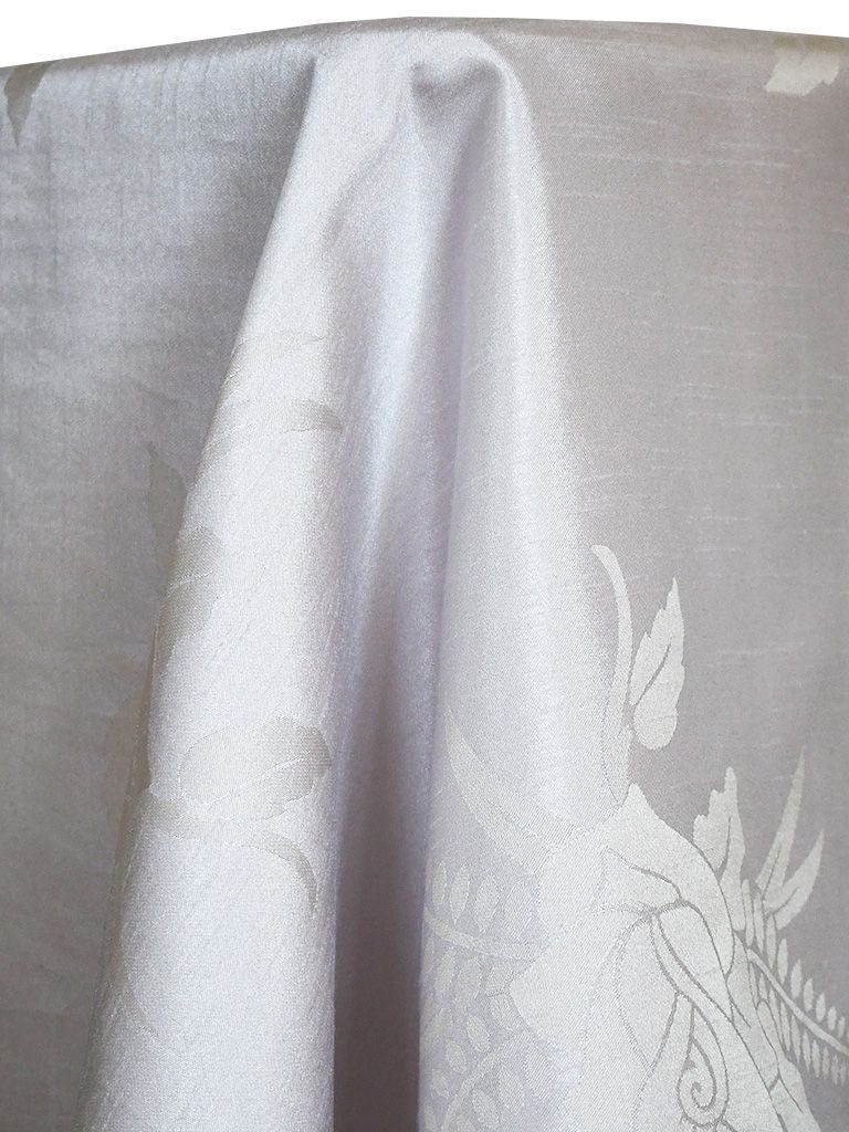 White fabric with floral pattern draping over something.