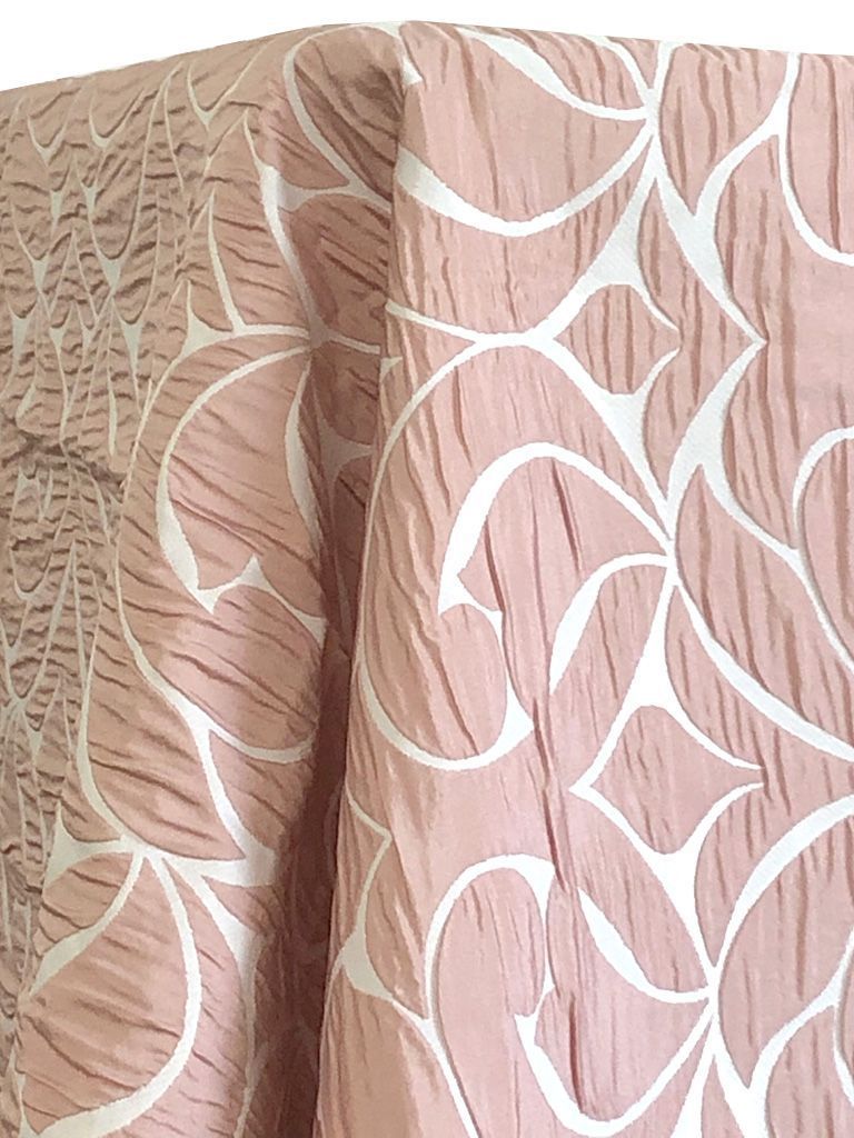 Pink fabric with a white floral pattern, draped.