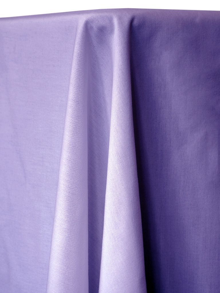 Light purple fabric draped over a surface, with soft folds and texture.