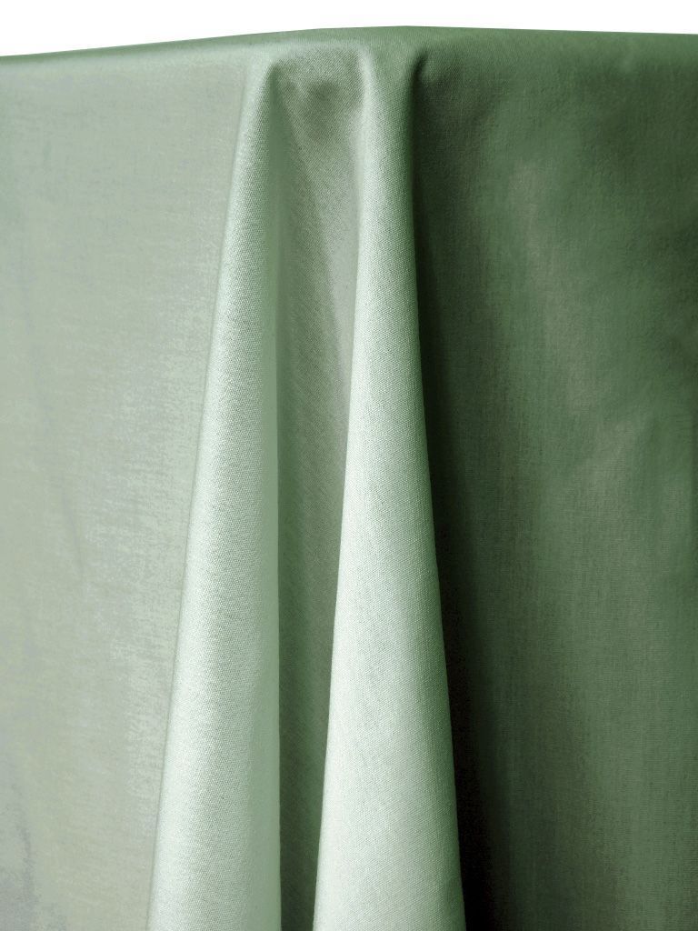 Green fabric draped over a table, with visible folds and a textured surface.