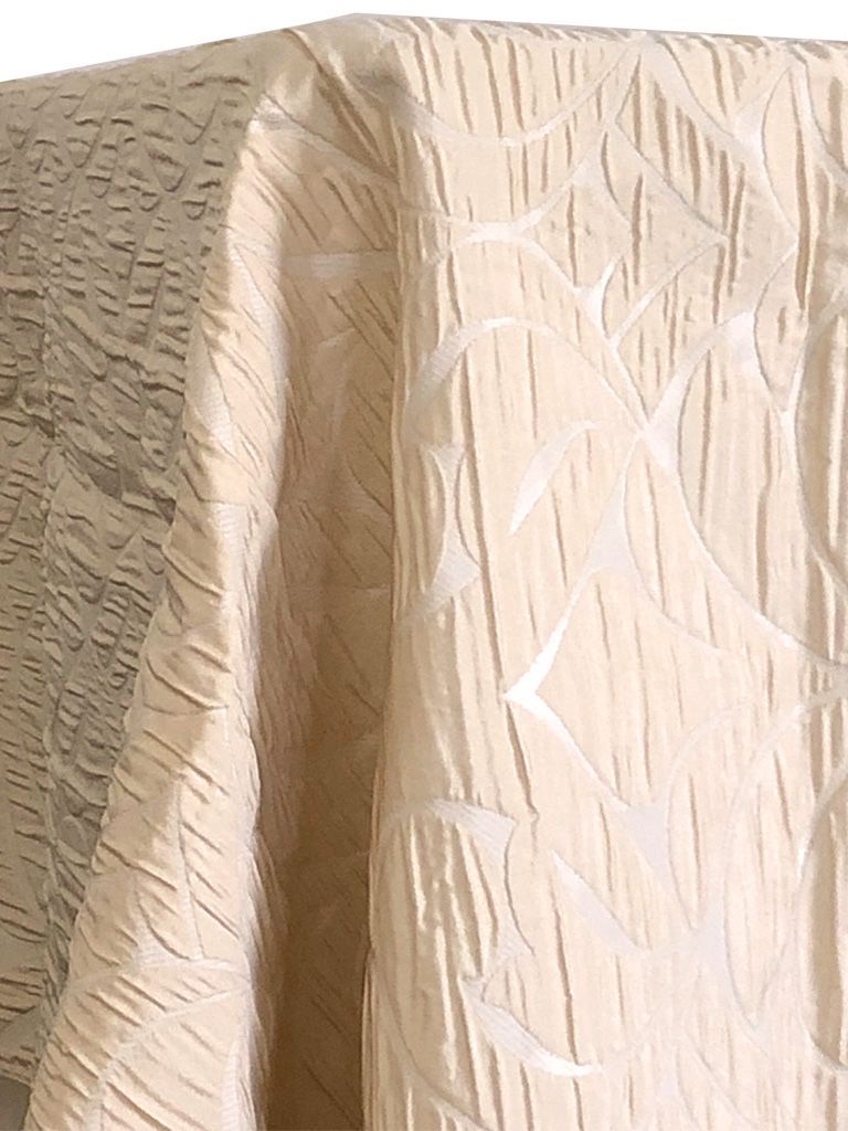 Beige patterned fabric with vertical ridges and a floral design.