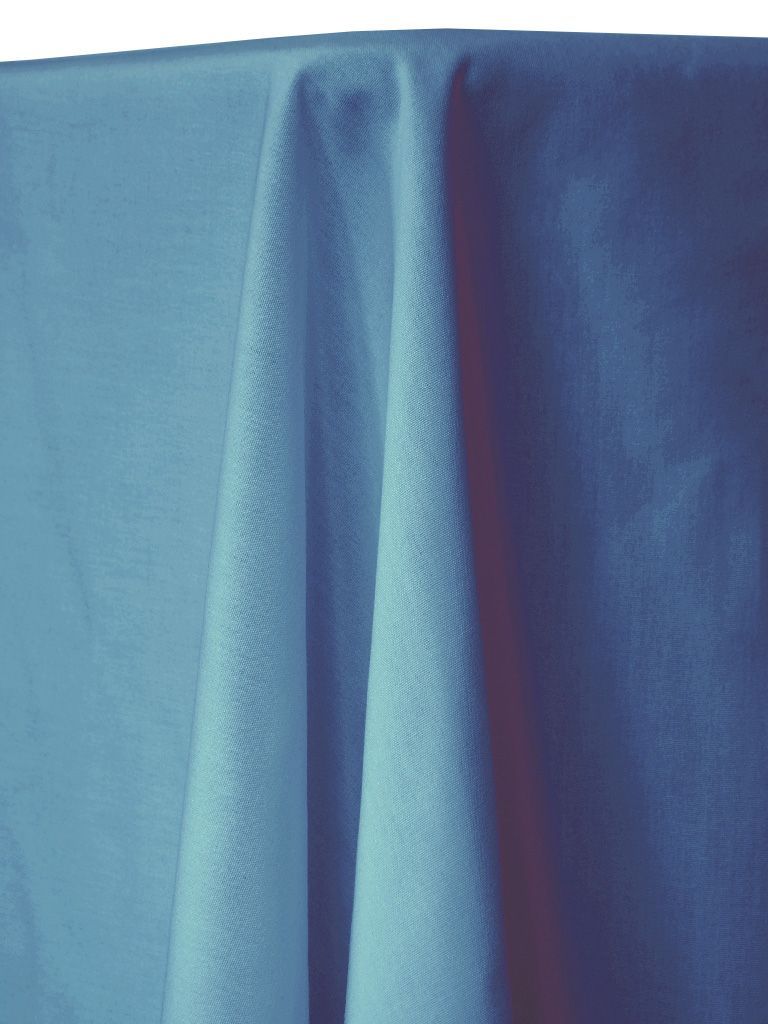 Light blue tablecloth draped over a table, with visible folds and shadows.