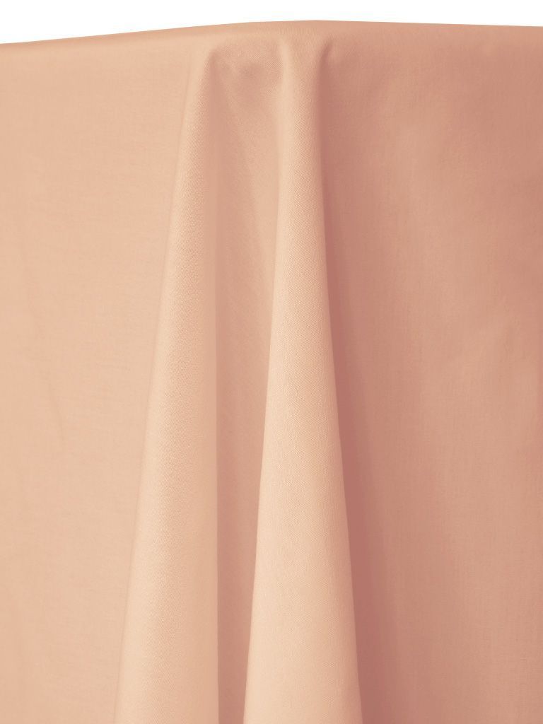 Peach-colored cloth draped over a table, with visible folds and textures.