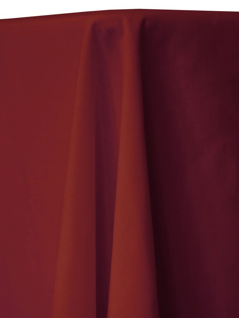 Red burgundy tablecloth draping over a table.