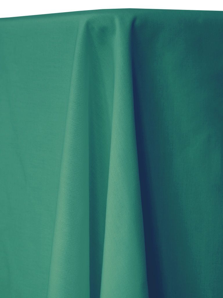 Teal green fabric draped over a table, with folds and shadows.