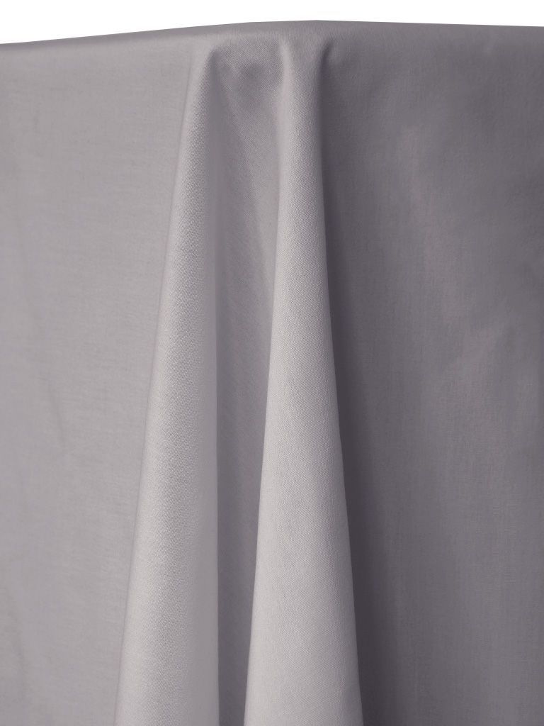 White fabric draped over a table, showing folds and textures.