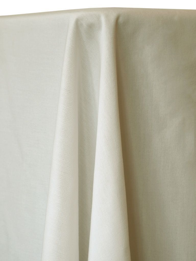 White tablecloth draped over a table, showing folds and texture.