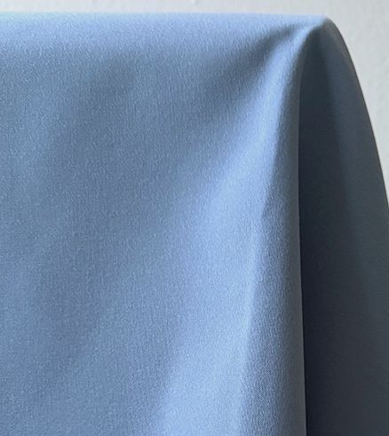 Blue fabric draped with a soft, matte texture.