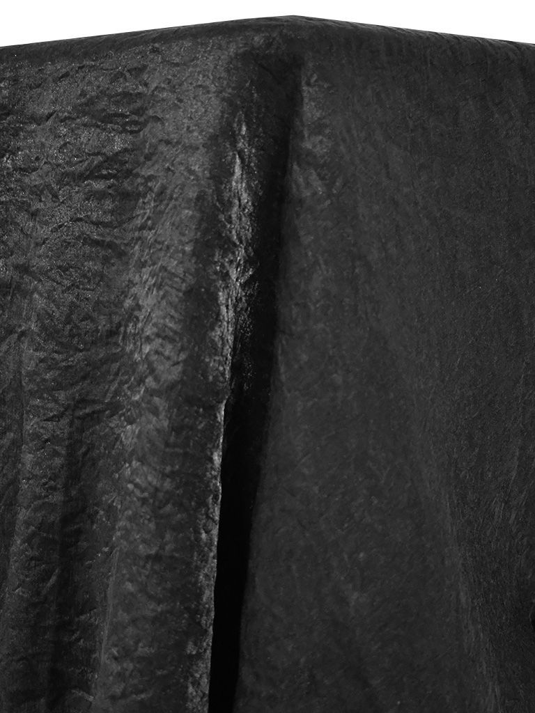 Black, crinkled fabric draped over a surface, creating deep shadows.