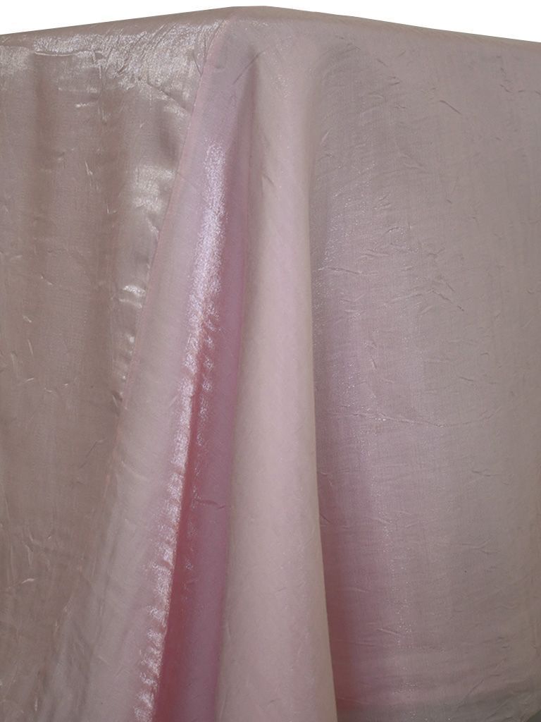 Pale pink, shimmering fabric draped over a table.