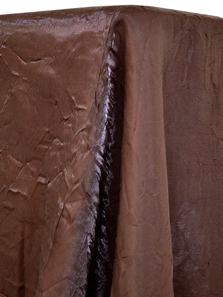 Brown, textured tablecloth with a reflective sheen draped over a table.