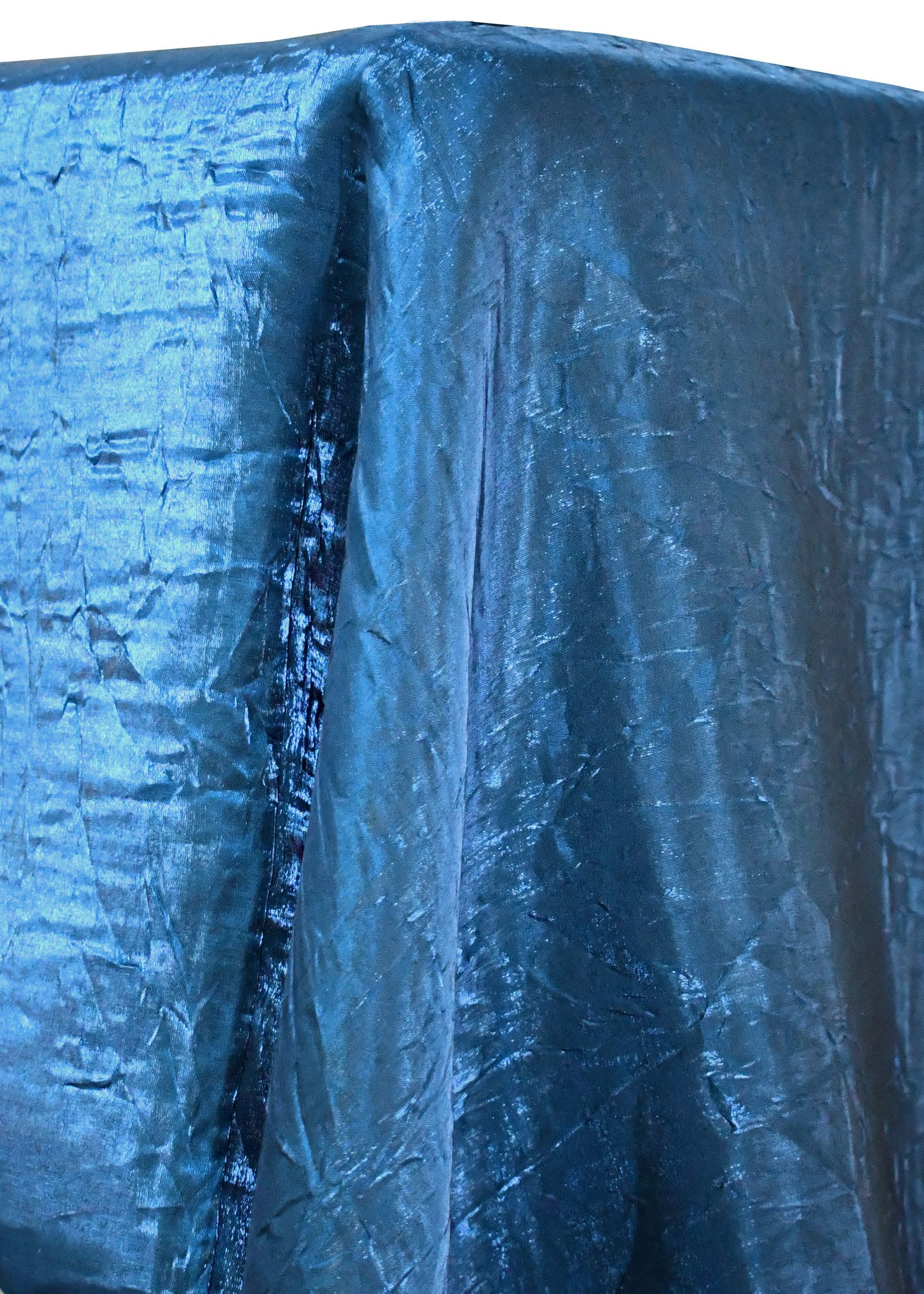 Blue iridescent fabric draped over a corner.