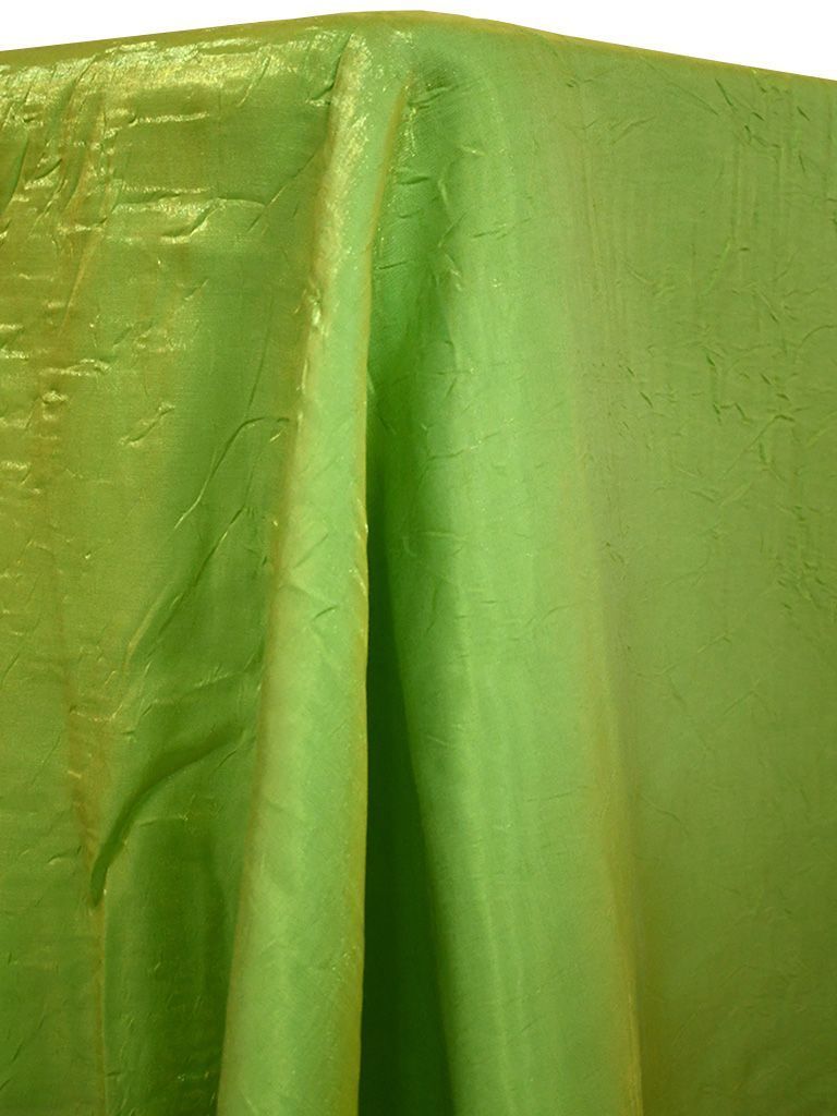 Lime green crinkle fabric draped over a table, reflecting light.