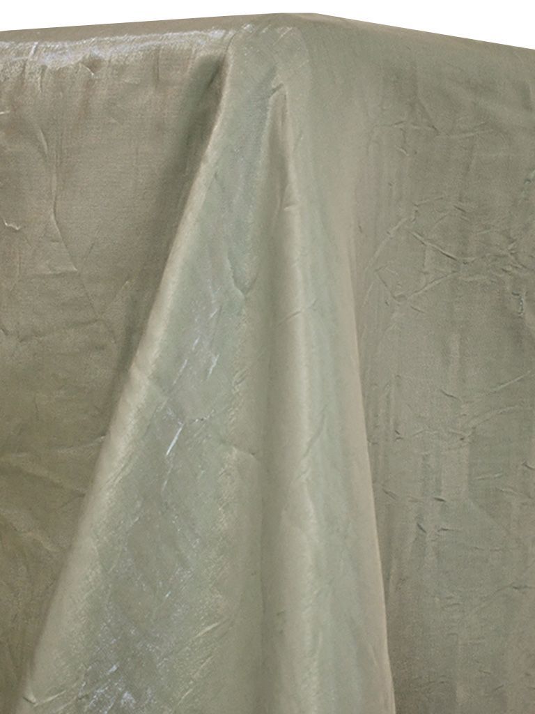 Folded light green fabric, draped over a surface, with visible texture and highlights.