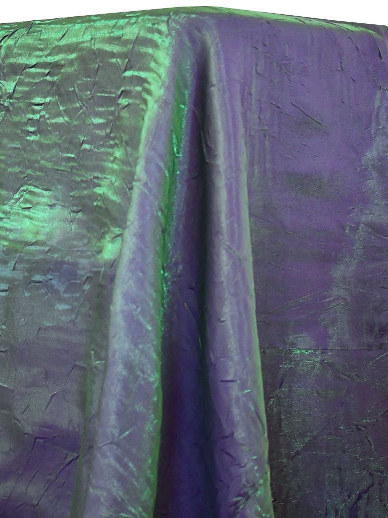 Purple and green iridescent fabric draped over a table.